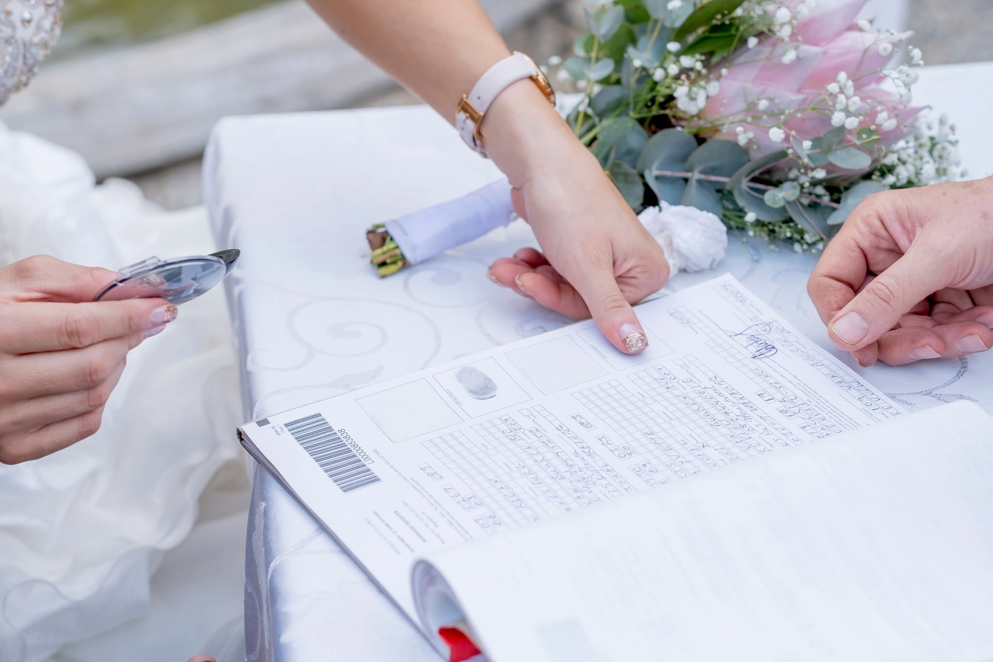 A couple signing the official marriage register